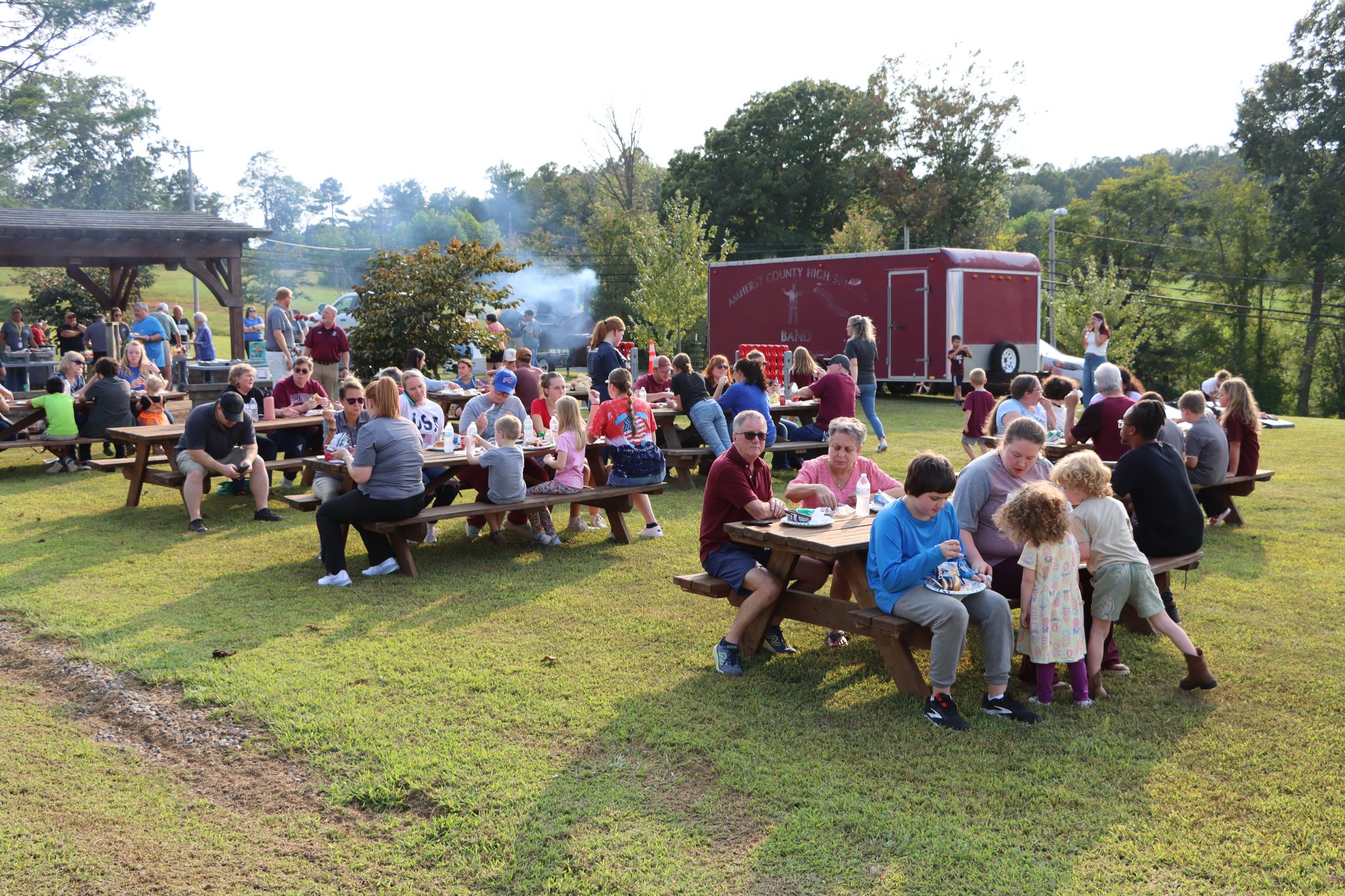 Wide shot of families eating together at the Amherst County Community Tailgate
