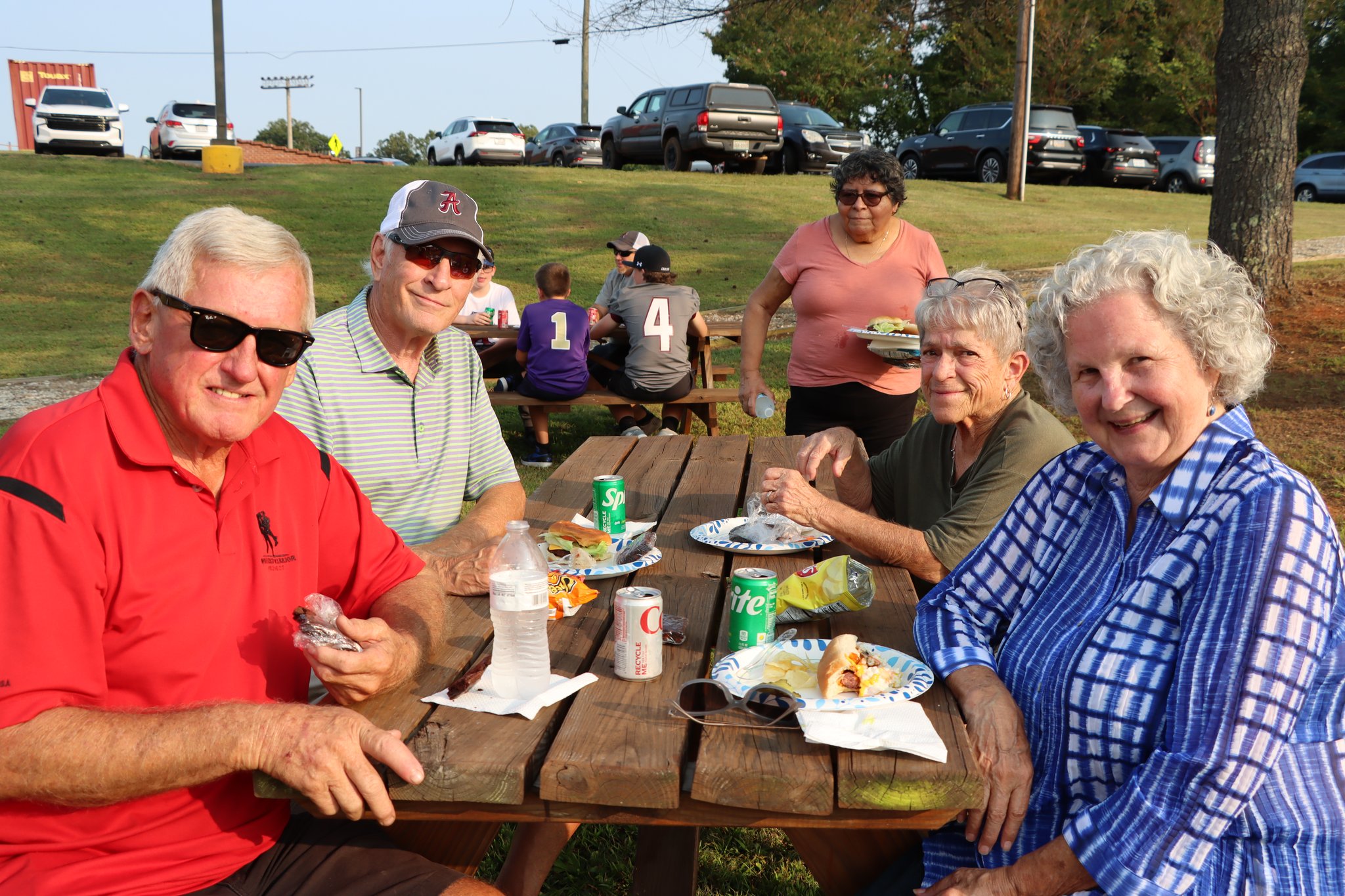 Multigenerational crowd sharing a picnic at the Amherst County Community Tailgate
