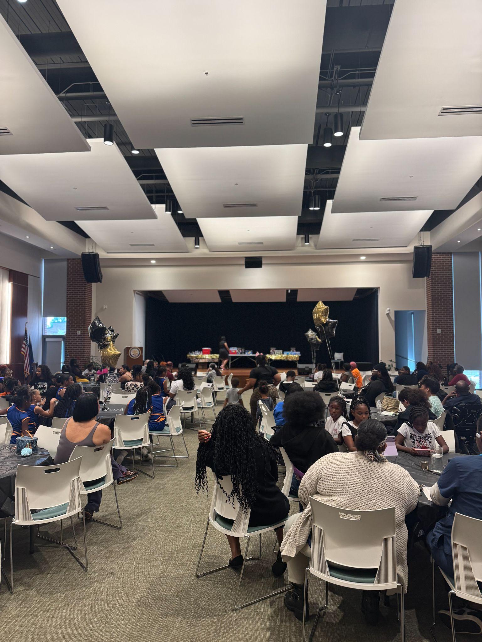 Families seated at tables during a Family Engagement University session, Petersburg