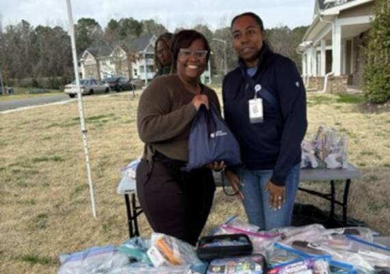Community members distributing hygiene kits in a neighborhood