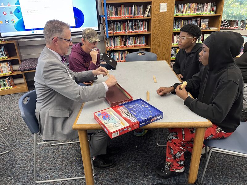 Mayor playing Jenga with middle school students
