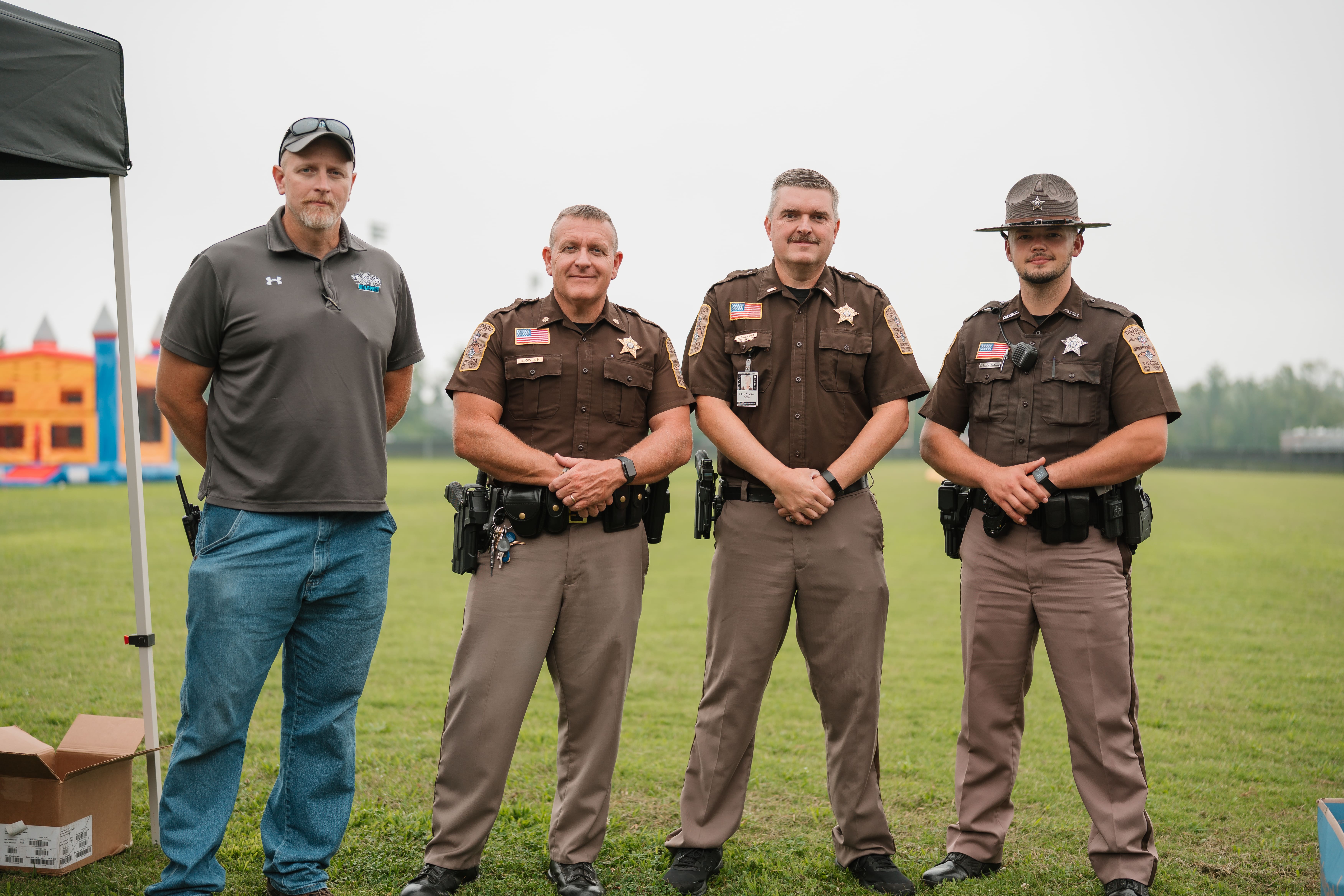 Dickenson County Sheriff's deputies with a community member at the Back to School Bas