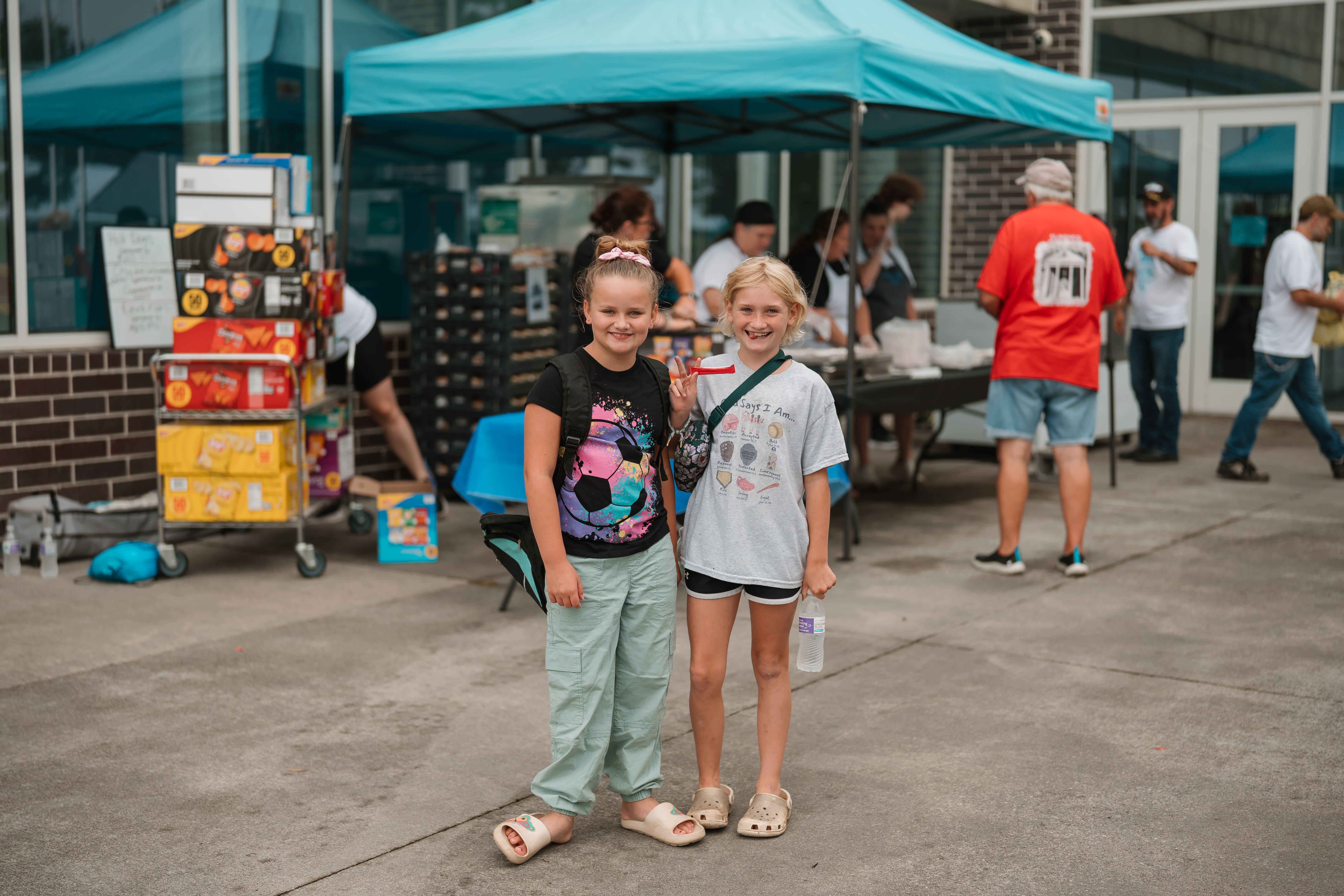 Two young girls smiling at the Dickenson County Back to School Bash community event
