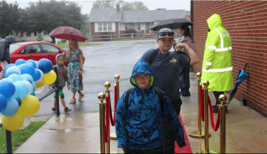 Red carpet welcome with balloon arch at Fairview Elementary first day of school, Grayson County