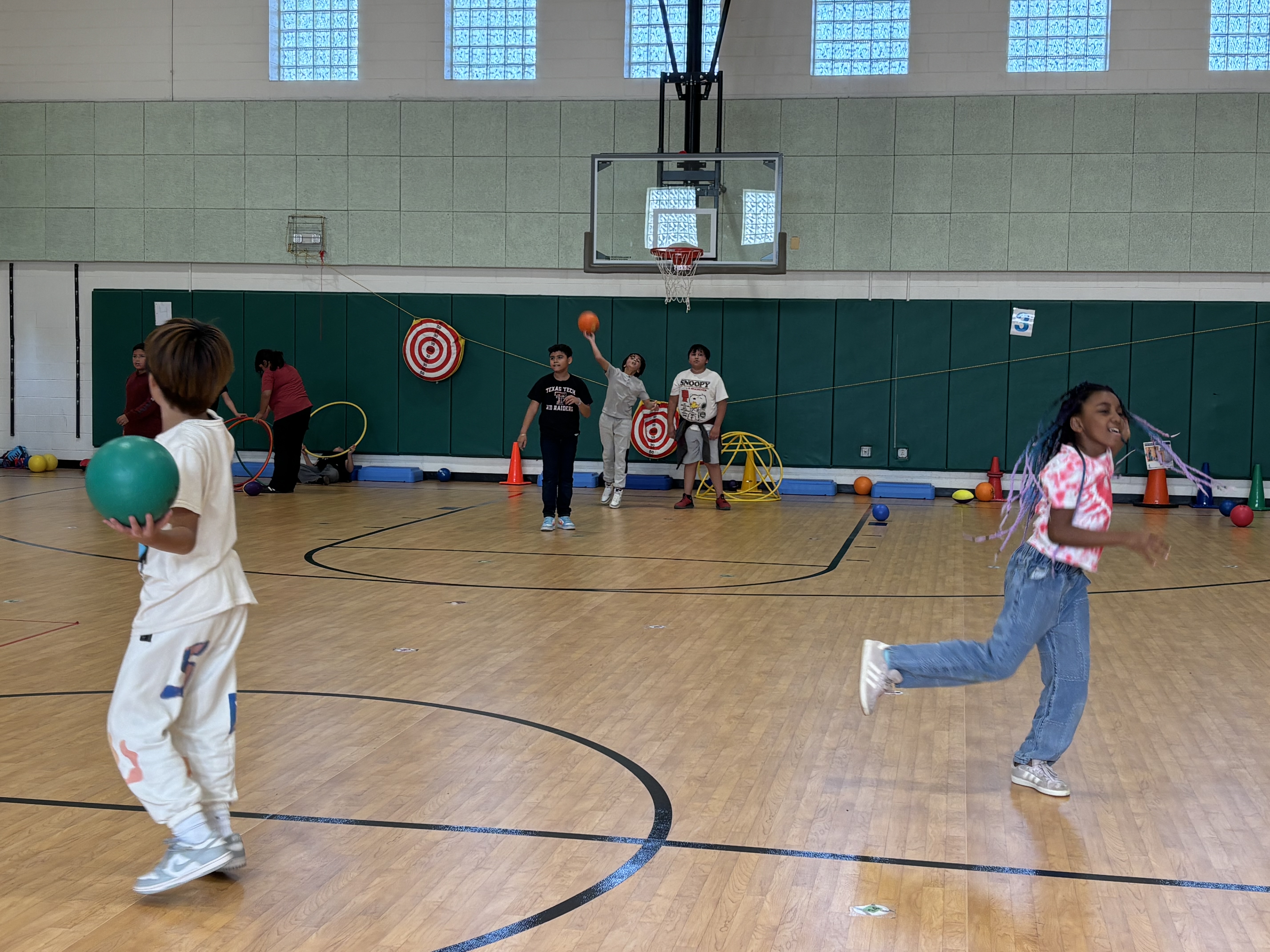 Students playing basketball and hula hoops in the Guilford Elementary Sports Club