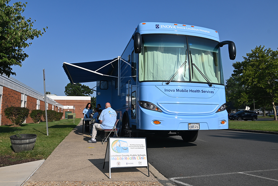 Inova Health Services mobile health clinic bus parked at a Loudoun County school