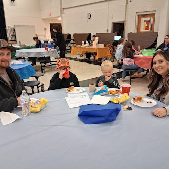 Families sharing dinner at a Norton Elementary community engagement event
