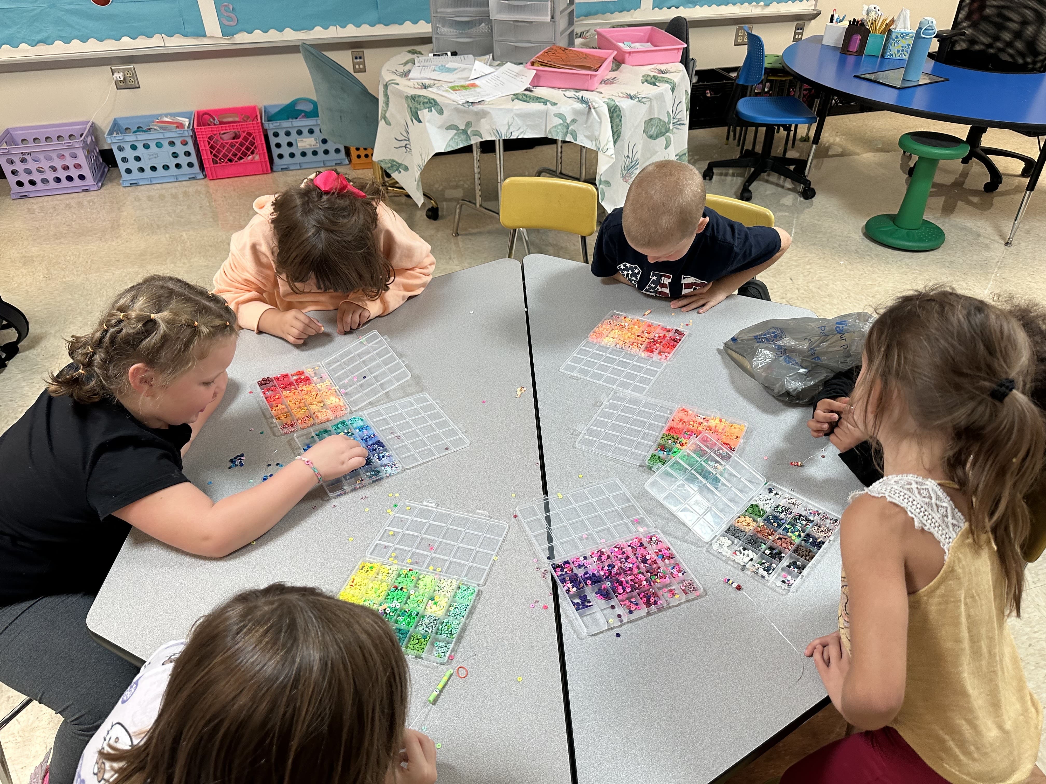 Students working with perler beads during after-school enrichment time at Norton Elementary