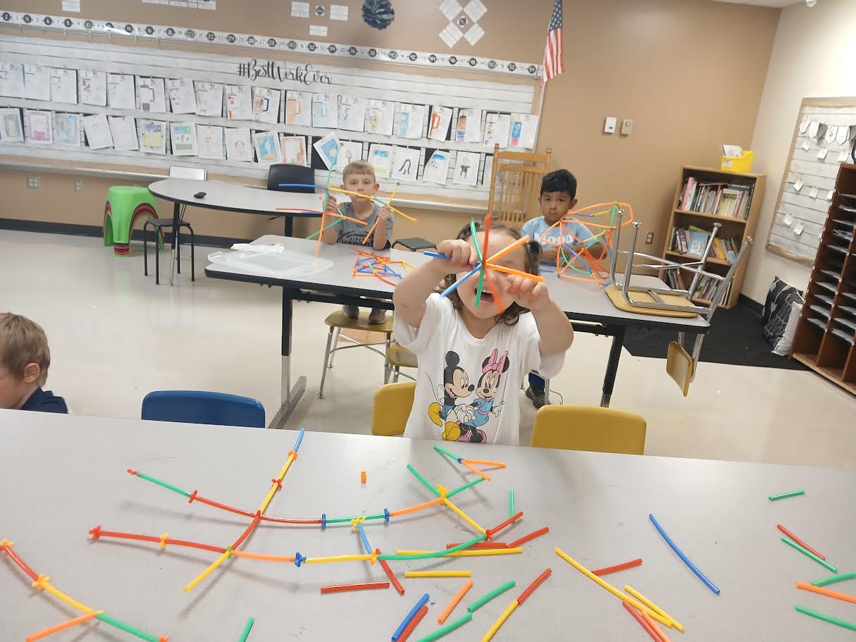 Students creating geometric straw art during STEM enrichment at Norton Elementary