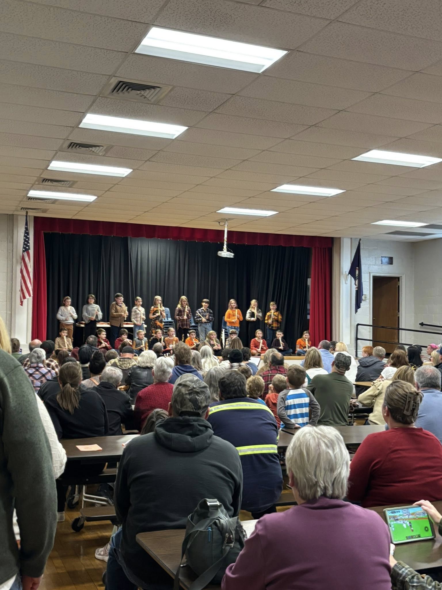 Students performing on stage to a full auditorium at Springfield Elementary School, Page County