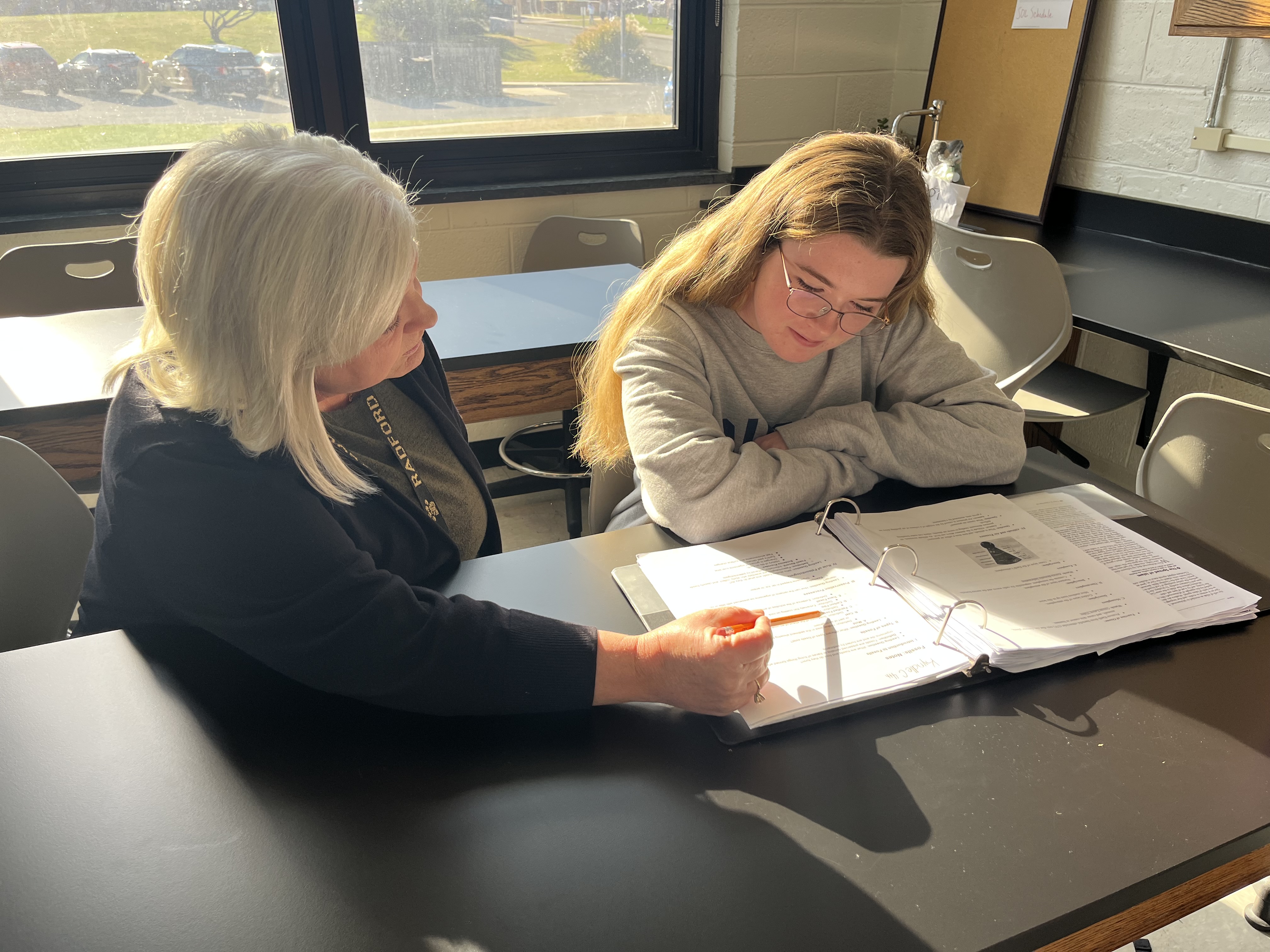NCS tutor Paige working one-on-one with a student during an evening session