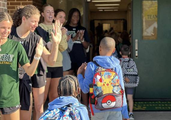 Cheer squad welcoming students at Magruder Elementary