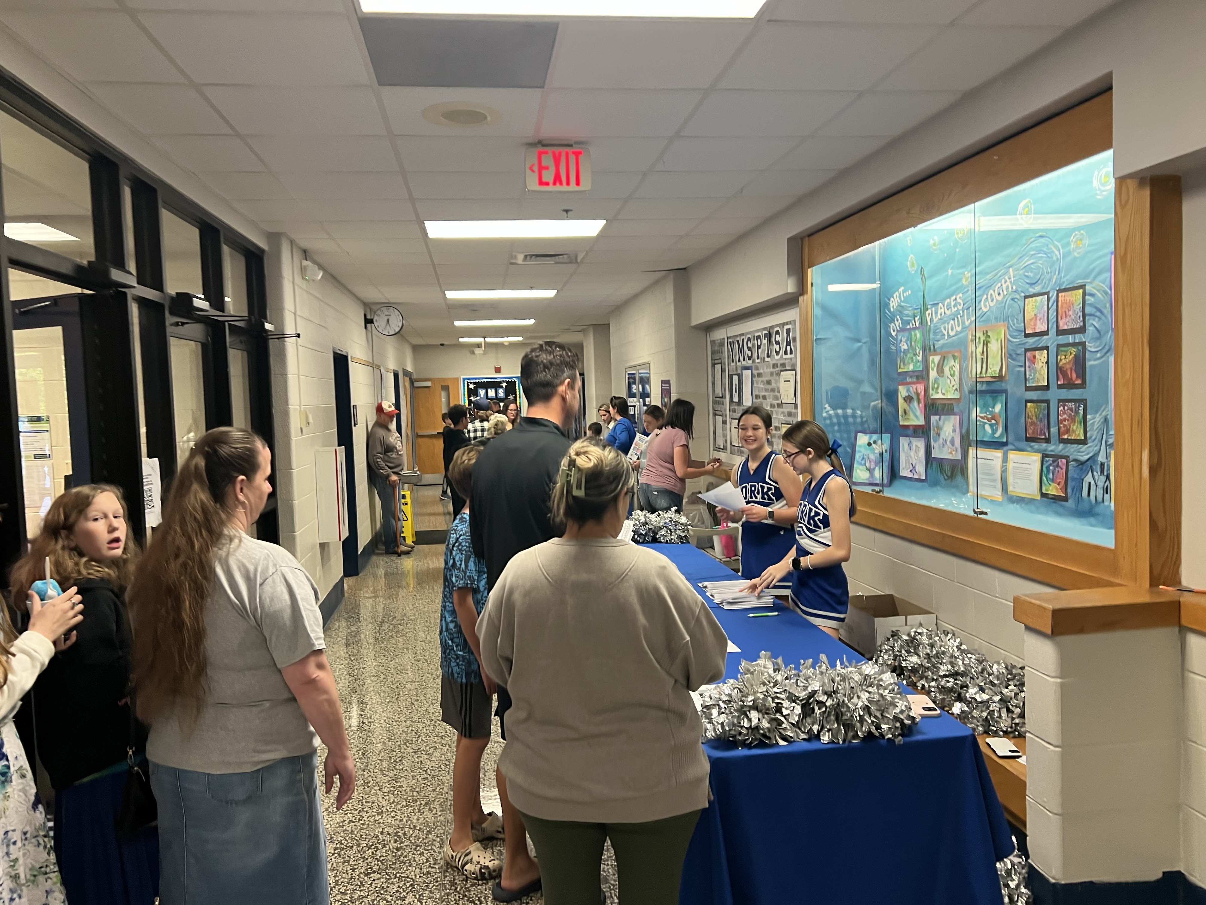 Cheerleader at a family engagement event table