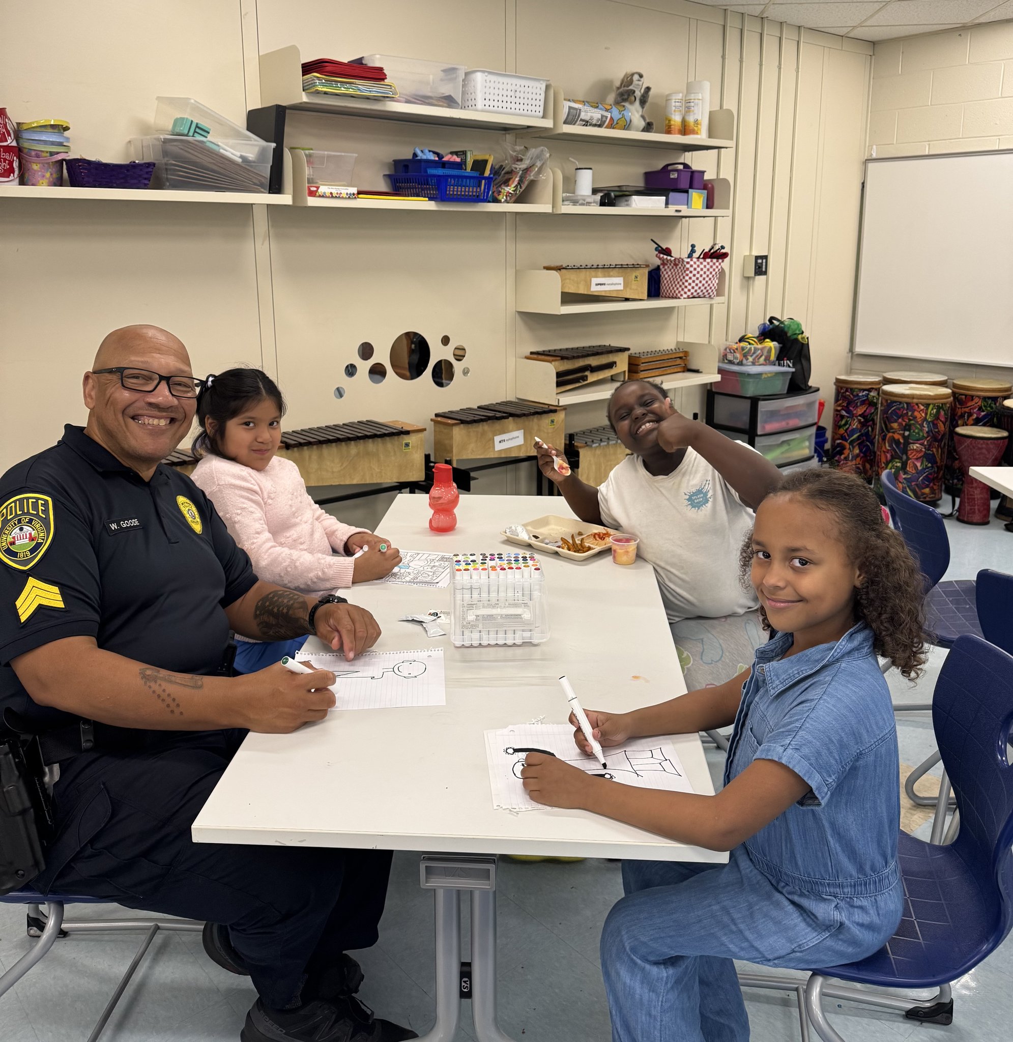 Officer and student doing an art activity together at Greer Elementary, CIS NOVA