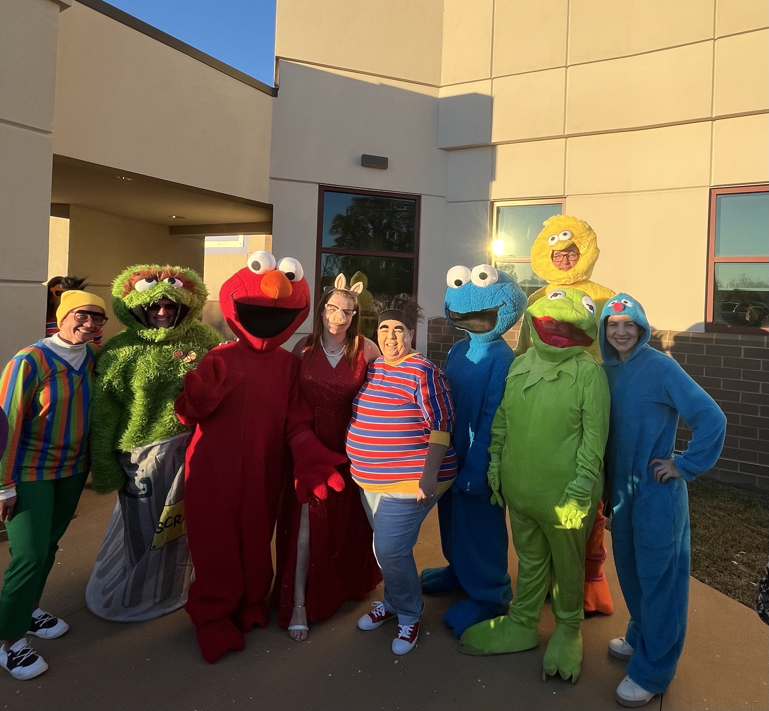 Staff in Sesame Street costumes at a LIFT Center literacy night, Fallon Park Elementary