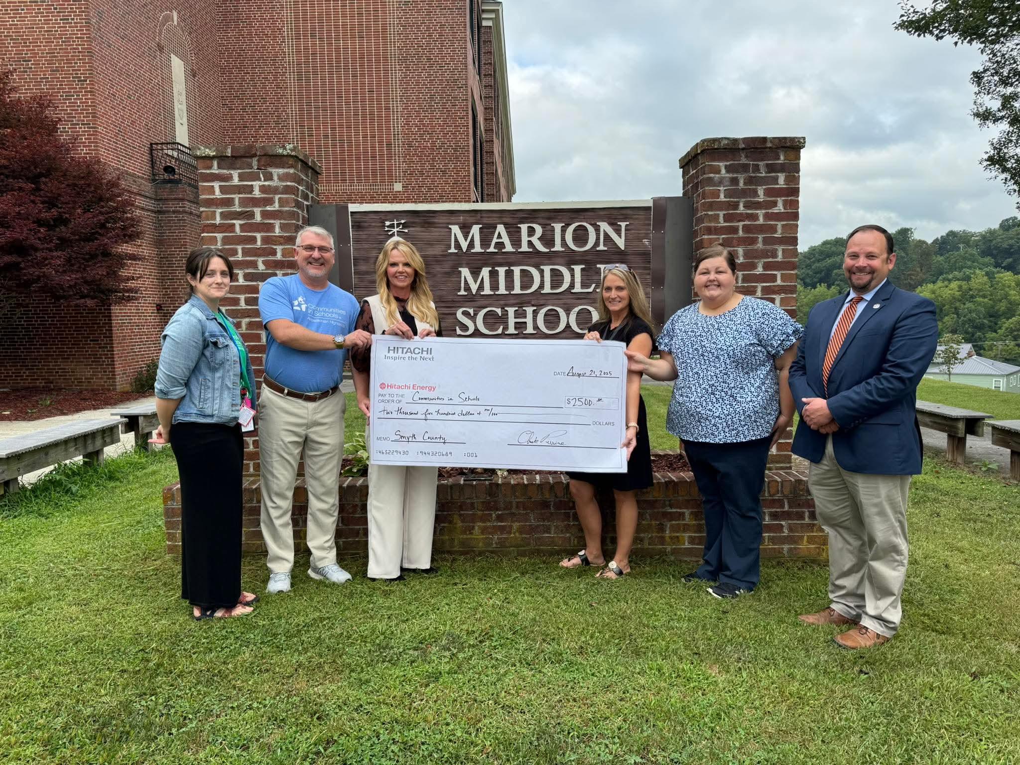 Hitachi Energy representative presenting a check to Marion Middle School, Smyth County